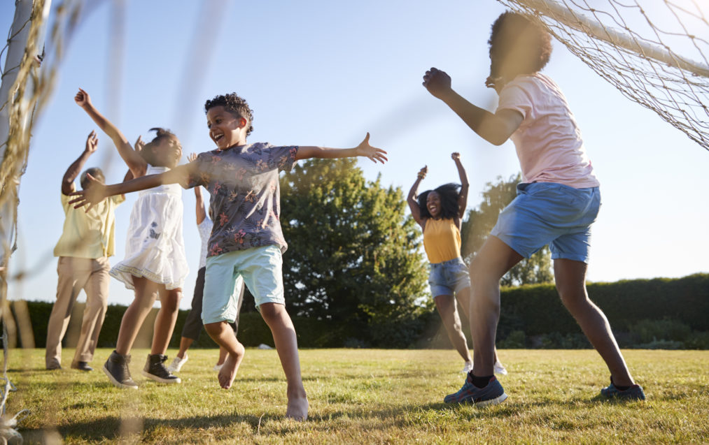 Celebrating goal at a multi generation family football game